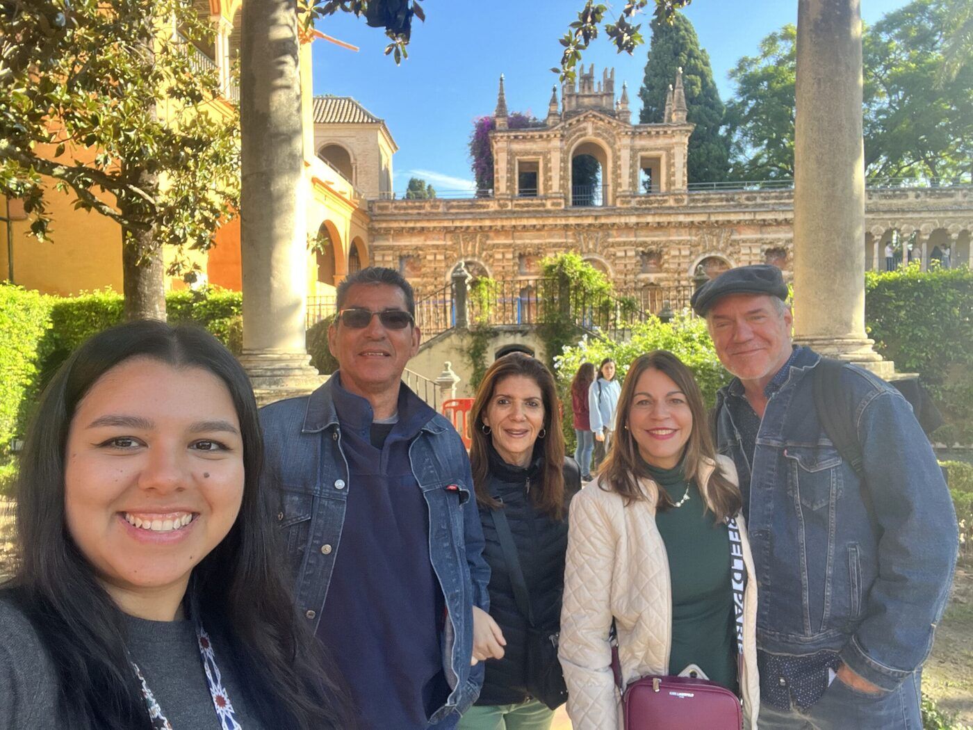 Selfie of a tour group enjoying winter sunshine in the Royal Alcázar gardens in Seville