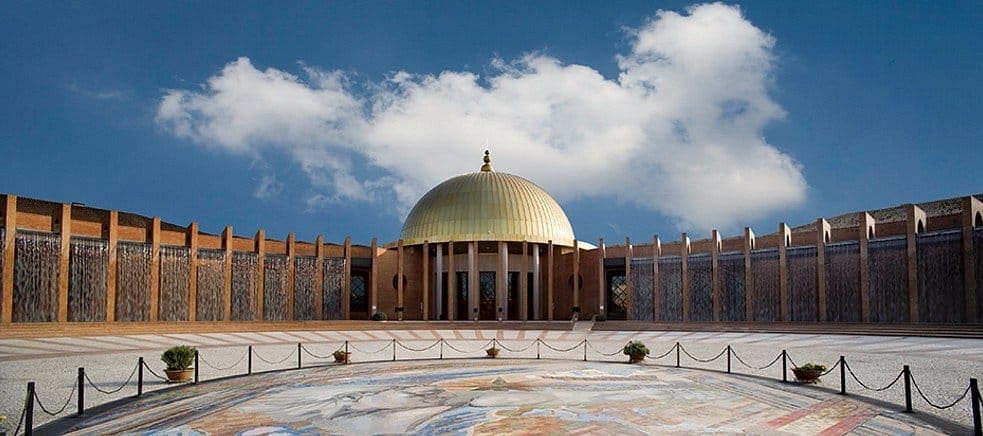 Golden-domed pavilion and circular mosaic plaza in Seville, host city of the UN summit