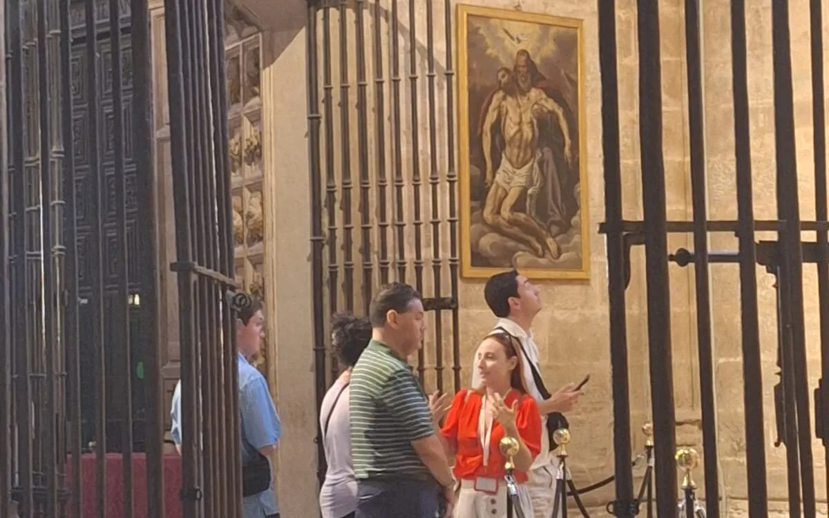 Travelers walking past Seville Cathedral at their own pace on a self-guided audio tour